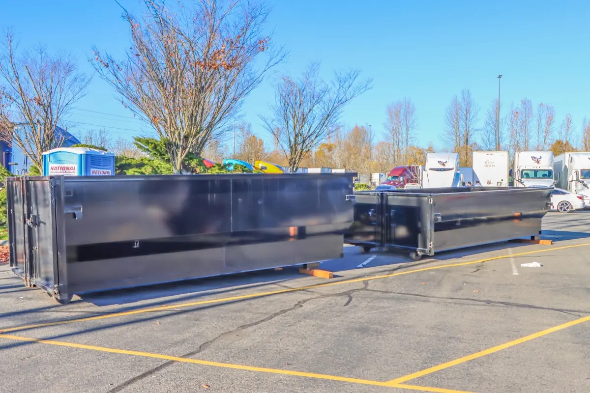 Professional dumpster rental service with roll-off container on residential driveway in Mechanicsburg